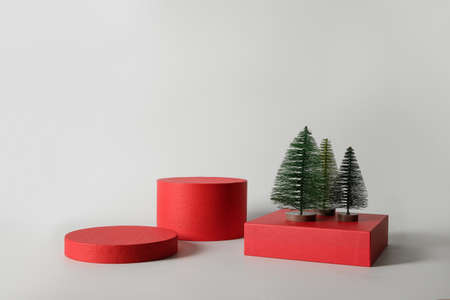 Xmas red stands with decorative Christmas tree for product. Template, mock up for presentation goods. Podium background.の写真素材