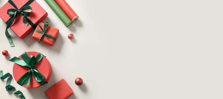 Christmas banner wrapping gifts with red and green decoration on gray. Preparation for Xmas...