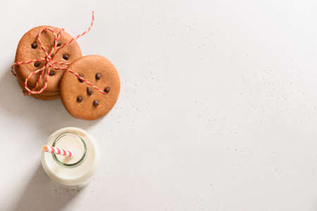 Milk for Santa Clauseand cookies on white background. Close up. View from above.