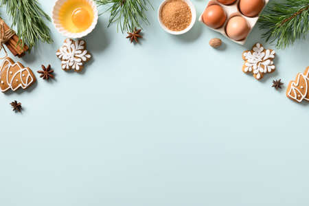 Christmas traditional cookies with ingredients for cooking on blue background. Space for text. View from above.の写真素材