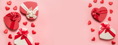 Valentines Day banner with red heart boxes and on pink background. Flat lay. Romance greeting card...