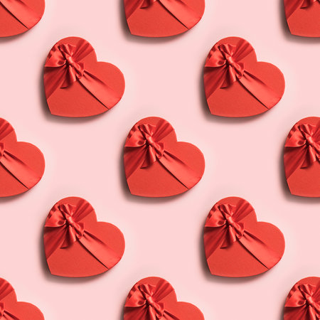 Valentine's day seamless pattern of red heart boxes on pink background. Greeting card.