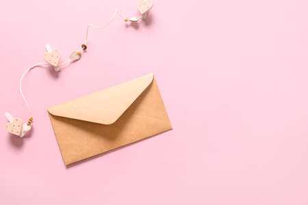 Valentines day greeting card with envelope and hearts on pink background. View from above. Copy space.の写真素材