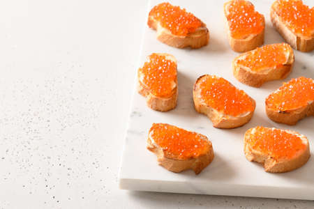 Sandwich with red caviar, tasty appetizer for party. Close up.の写真素材