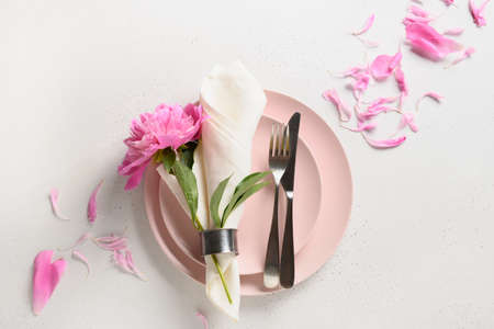 Elegance romantic table setting with pink peony flowers on a white table. View from above.の写真素材