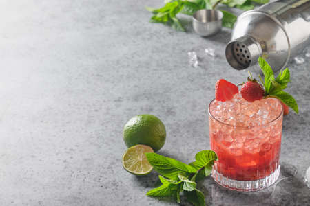 Cocktail with strawberries puree, soda, lemonade, ice cube, and lime. Homemade freshness summer beverage. Horizontal orientation with copy space.の写真素材