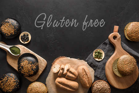 Healthy bread of buckwheat, spirulina, charcoal on black background with text - Gluten free.の写真素材