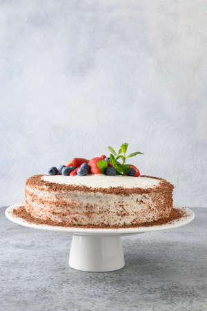 Homemade cake of mascarpone and biscuit decorated berries, mint, strawberries and blueberries.