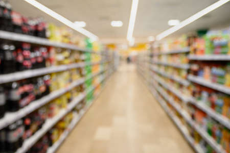 Shelves in supermarket as blurred background for design.