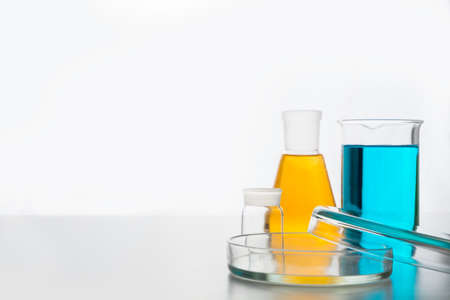Chemistry glassware with yellow and blue liquid for science research and experiment.