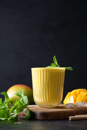 Indian mango or turmeric lassi on black backgroundの写真素材