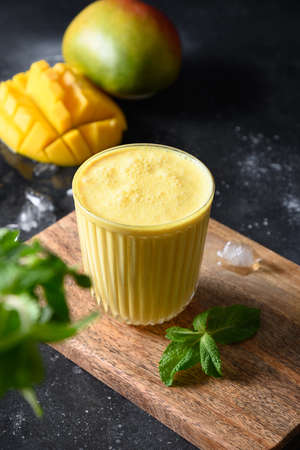 Indian mango or turmeric lassi on black backgroundの写真素材