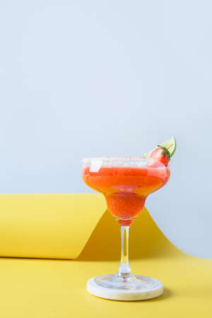 Classic Margarita cocktail with lime juice and ice cube on black background. Vertical orientation.の写真素材