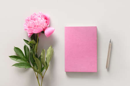 Creative female mockup with coffee cup, peony flowers, sketchbook for planning.の写真素材