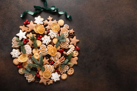 Creative Christmas ball of assorted cookies, cinnamon, anise stars, berries, orange chips, spruce branches.の写真素材