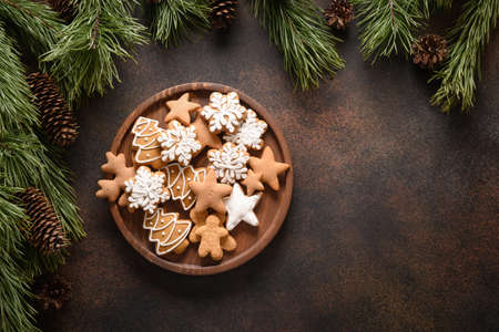 Christmas homemade assorted glazed cookies in wooden plate.