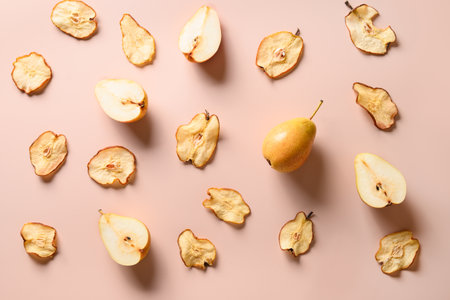 Fruits pattern of fresh pear and dry chips on a beige background.の写真素材