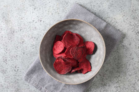 Vegetable beetroot vegan chips in gray bowl.の写真素材