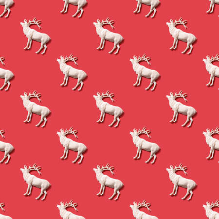 Seamless pattern with Christmas white deer on red. New Year or Merry Christmas texture.の写真素材