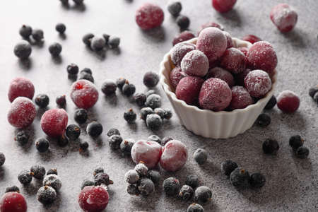 Frozen mix berries red sour cherry and black currant on gray background.の写真素材