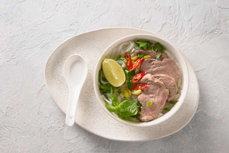Pho Bo Soup with beef in bowl on white backgound. Vietnamese cuisine.の写真素材