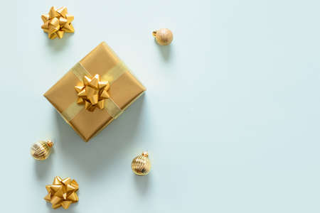 Christmas golden gift and balls. Top view with copy space. Xmas holiday greeting card.の写真素材