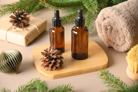 Christmas Spa concept with cosmetic aroma oil, pine cones. Winter holiday for body care, harmony and...