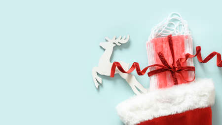 Christmas Santa hat with protective medical face mask and evergreen pine branches.の写真素材