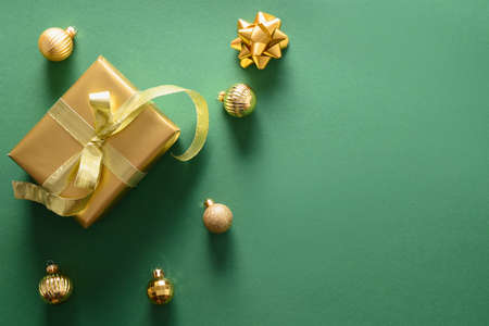 Christmas gold gift and baubles. Top view with copy space. Xmas holiday greeting card.の写真素材