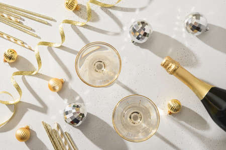Festive New Year champagne and Christmas silver baubles on white background.の写真素材