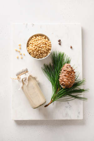 Cedar nut milk and nuts on white background. Alternative plant based milk.の写真素材