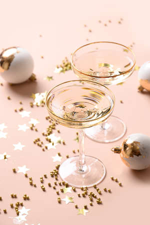 New Year champagne and Christmas gold baubles on white background.の写真素材