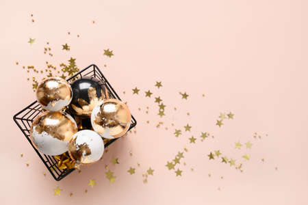 Christmas balls with gold potal on pink background with copy spaceの写真素材