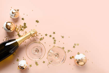New Year champagne and Christmas gold baubles on white background.の写真素材