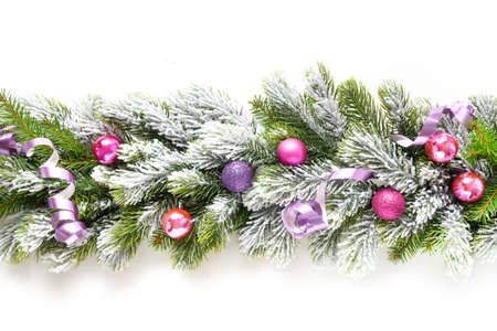 Christmas banner with violet baubles in row on snowy evergreen branches.の写真素材