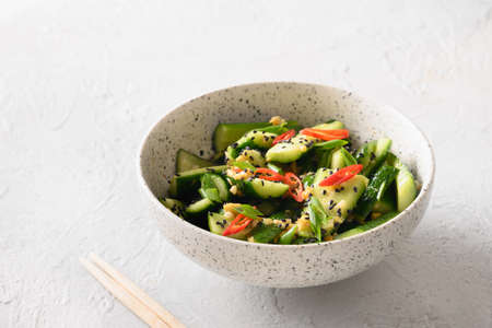 Asian spicy cold appetizer Broken Cucumbers with fresh coriander, ginger, pepper chili, black vinegar.の写真素材