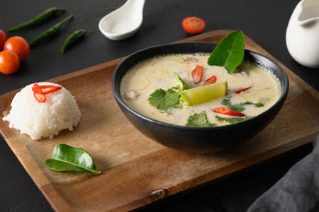 Asian Tom Kha Gai soup. Spicy coconut with chicken, cherry tomato.