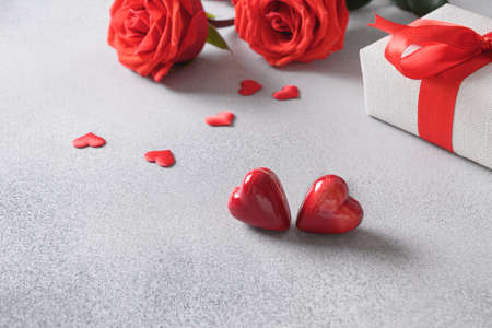 Valentines day two heart shaped sweets and romantic gift, bouquet of red roses.