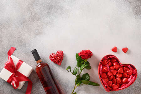 Valentines day card with champagne, romantic gift and red roses flowers