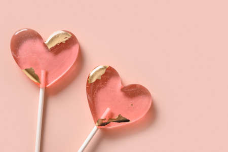 Lollipops pink candy on stick. Valentines day romantic greeting card.の写真素材