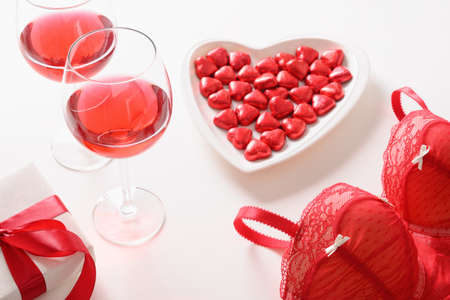 Set for romantic dating,Valentines day, red love gift, bustier underwear, wine and chocolate sweetsの写真素材