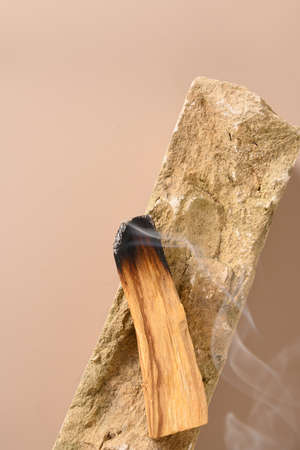 Palo Santo stick incense burning on stone.の写真素材
