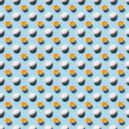Organic white eggs and yolk with shadow on blue background. Seamless pattern.