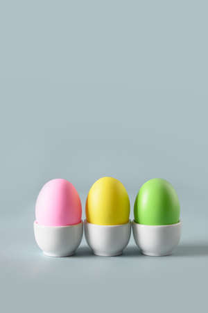 Easter colorful chicken eggs in decorative white stands.の写真素材