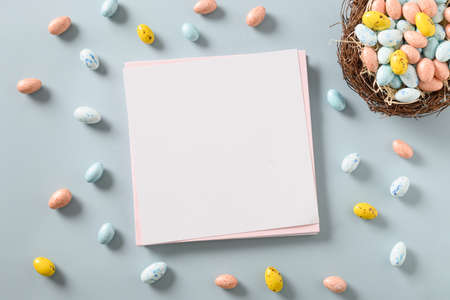 Easter pink blank for greetings with chocolate eggs and nest.