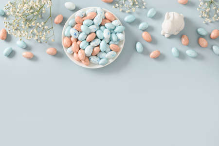 Easter mock up with pastel chocolate eggs on blue background.の写真素材