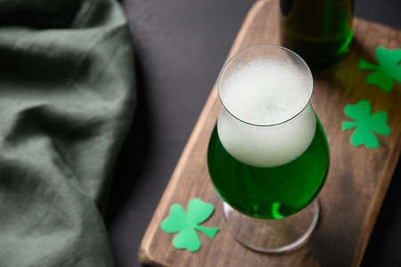 Patricks day green beer in glass on black.の写真素材