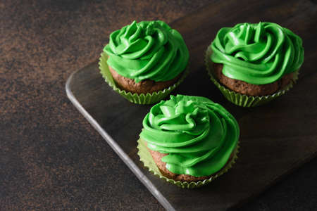 St. Patricks Day homemade cupcakes with green whipped cream.の写真素材
