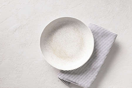 White empty plate with kitchen towel on white background. View vrom above. TKKitchen and cooking template, mock up.の写真素材