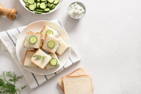 Cucumber sandwiches with ricotta and dill on white background. Top view. Copy space.の写真素材